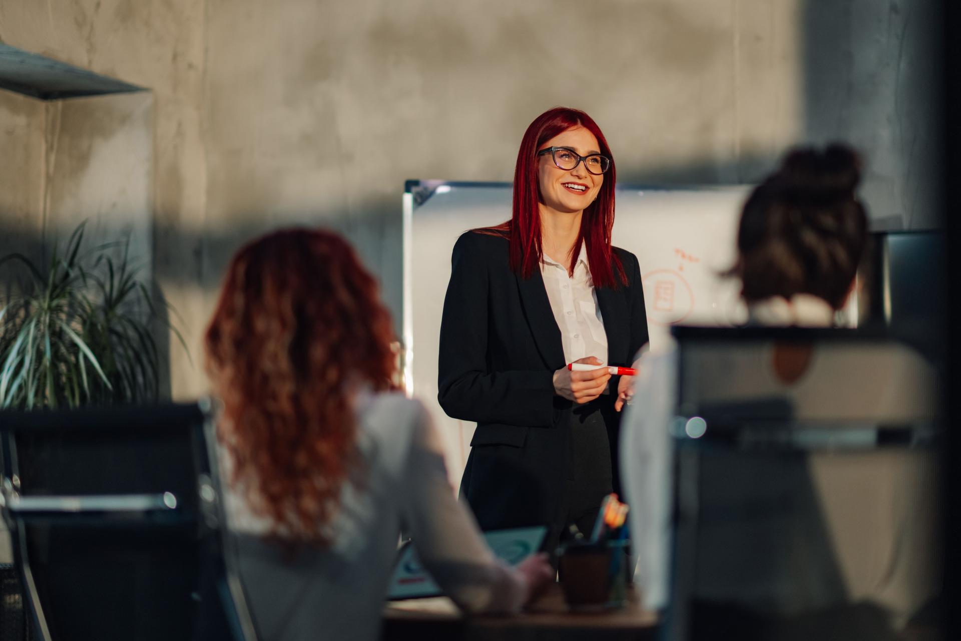 Female manager giving speech and presenting marketing strategy with team